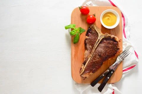 T-bone beef stake served on a cutting board Stock Photos