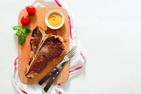 T-bone beef stake served on a cutting board Stock Photos