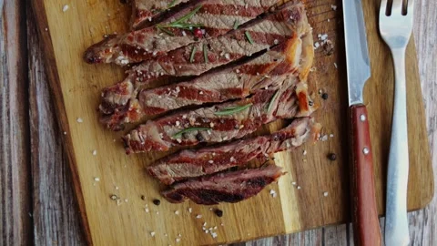 T bone beef steak grill sliced on a board. Top view. Close up. Stock Footage 256041839