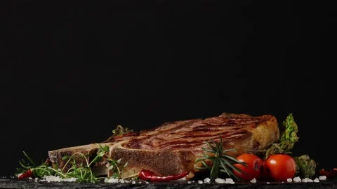 T bone beef steak, grilled. Presentation of the dish. Rotation. Black backgro Stock Footage 155154548