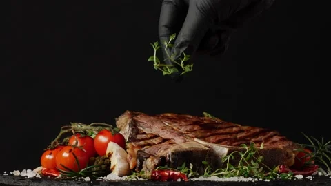 T bone beef steak, grilled. Presentation of the dish. Rotation. Black backgro Stock Footage 155154591