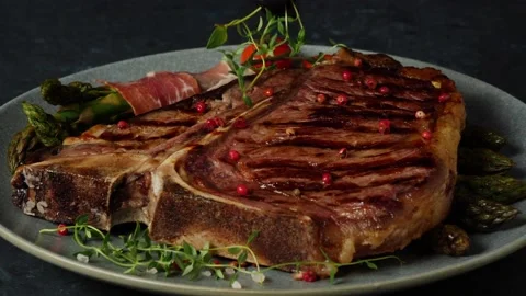 T bone beef steak, grilled. Presentation of the dish.  The cook is decorating Stock Footage 155154626