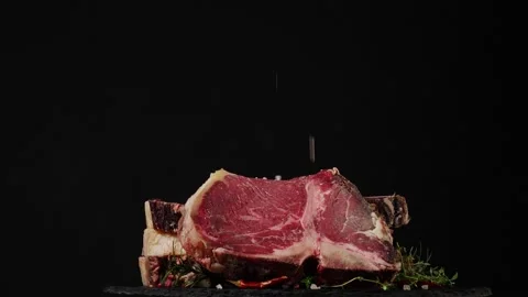 T bone. Raw beef steak. Presentation of the dish. Rotation. Black background. Stock Footage 155152186