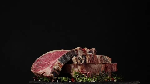 T bone. Raw beef steak. Presentation of the dish. Rotation. Black background. Stock Footage 155154651