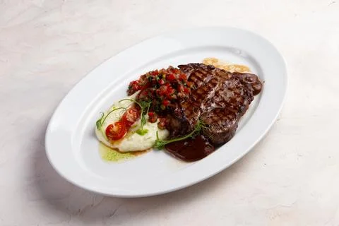 T-bone steak and mashed potatoes in a plate. Stock Photos