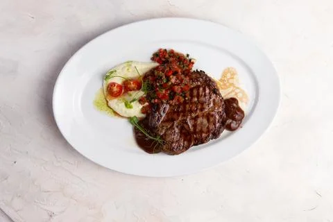 T-bone steak and mashed potatoes in a plate. Stock Photos