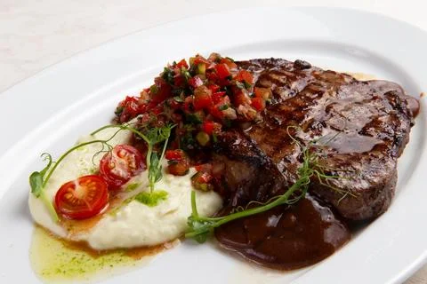 T-bone steak and mashed potatoes in a plate. Stock Photos