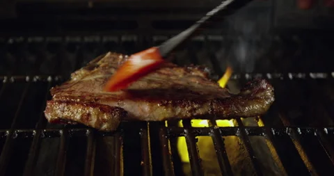 T-Bone Steak On Barbecue Grill Flames Stock Footage 243424877