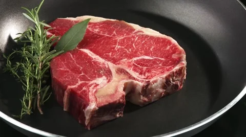 T-bone steak in a frying pan Stock Footage 8572516