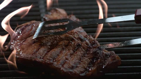 T-Bone steak on grill in slow motion, shot on Phantom Flex 4K Stock Footage 55683831