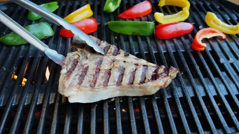 T- bone steak grill turn over on barbecue. Slow motion Video stock 265460362