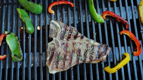 T- bone steak grill with vegetables on a cast iron barbecue. Top view Stock Footage 265460423