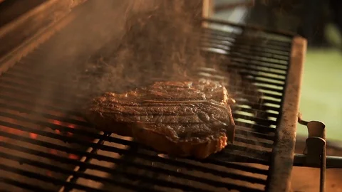 T-bone steak of marble beef was steaming on a hot grill rack Stock Footage 107676034