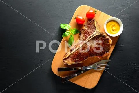 T-bone steak served and ready to eat Stock Photos