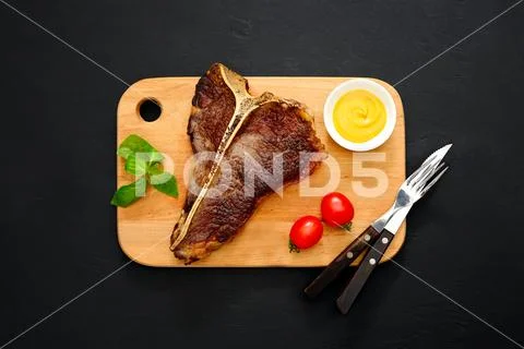T-bone steak served and ready to eat Stock Photos