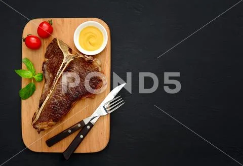 T-bone steak served and ready to eat Stock Photos