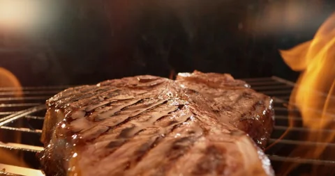 T bone steak sizzling on a grill 스톡 동영상 311831571