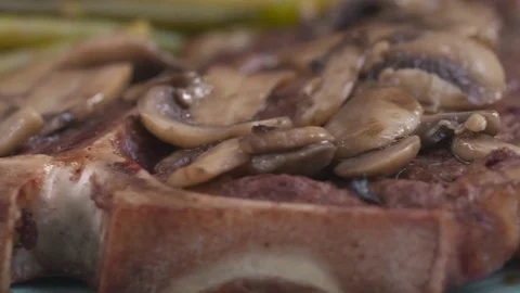 A T-Bone steak spins in slow motion in close up. Stock Footage 72544085