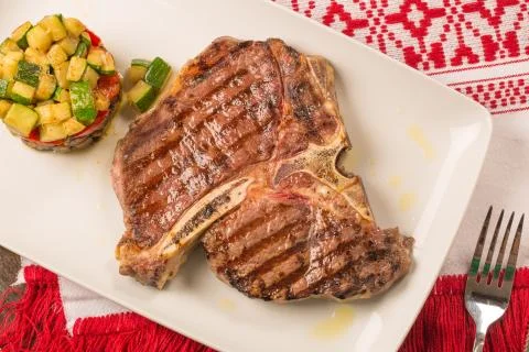 T bone steak with vegetables Stock Photos