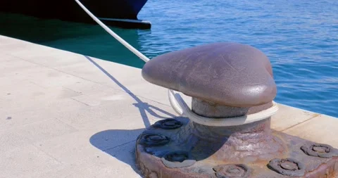 T head bollards in the harbor with a rope from a moored boat. Stock Footage 133196538