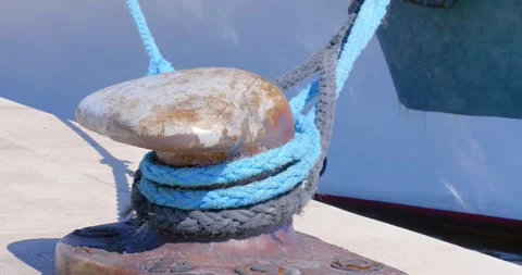T head bollards in the harbor with a rope from a moored boat. Stock Footage 133196548
