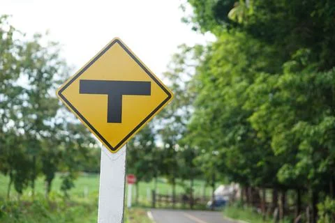 T junction, intersection sign yellow sign. Concept, Transportation symbol. Stock Photos