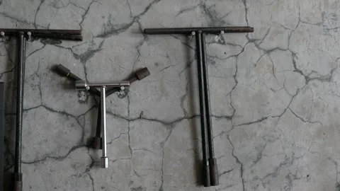 T-key tool hanging on the cracked wall. Stock Footage 336577429