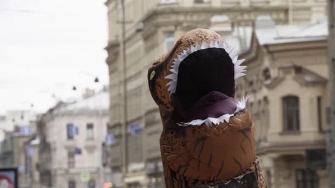 T rex mascot costume head shaking at city street Stock Footage 84932542