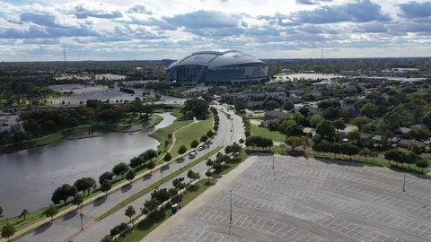 AT&amp;T Stadium above empty lots and a lakeside road Vídeo Stock 97727899