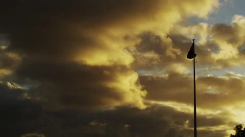 T_Lapse View of Flag Pole With Stormy Clouds at Sunset Video stock 61414747