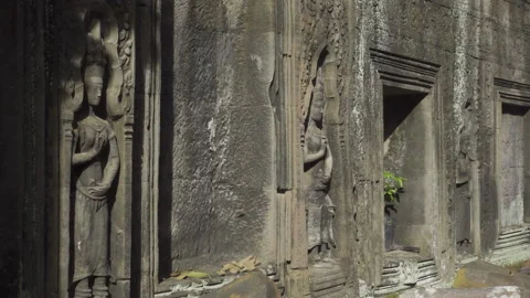 Ta prohm temple wall sculptures inset apsaras pan right Stock Footage 227264796