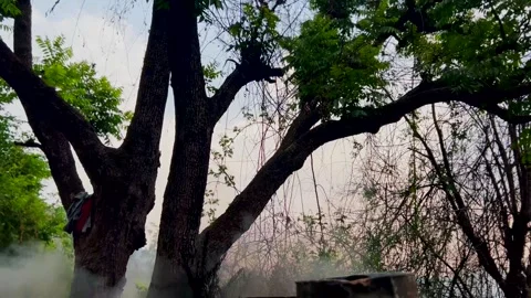Taarcoal heating up with fire for raod constrction in hill station Stock Footage 279801296