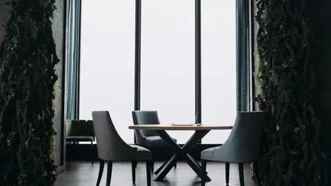 Table against the backdrop of panoramic windows overlooking the city Stock Footage 274466676