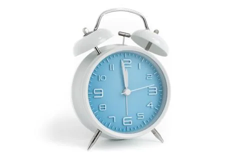 Table alarm clock with time 1 minute to 12 hours with blue clock face, 11.59  Stock Photos