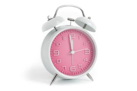 Table alarm clock with time 1 minute to 12 hours with pink clock face, 11.59  Stock Photos