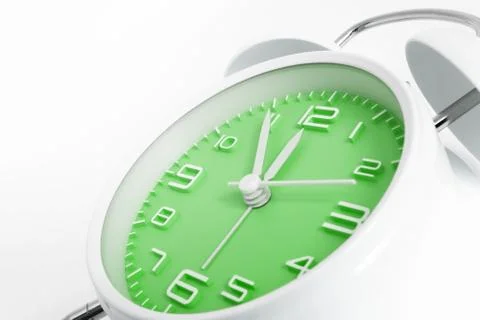 Table alarm clock with time 5 to 12 with green clock face, 11.55 AM PM, on wh Stock Photos