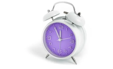 Table alarm clock with time 5 to 12 with purple clock face, 11.55 AM PM, on w Stock Photos