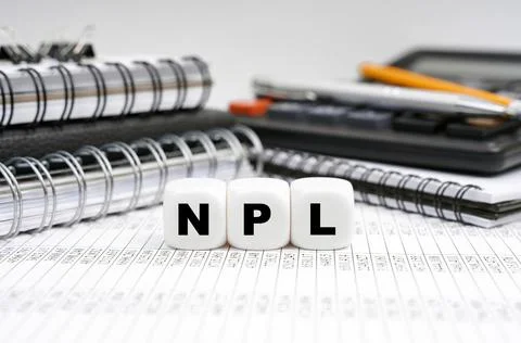 On the table, among office objects, cubes with the inscription - NPL 写真素材