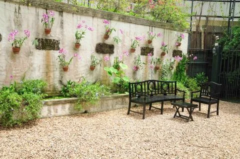 Table and bench set in garden, vintage style. Stock Photos