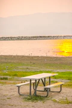 Table and bench with view of Lake Utah at sunset Stock Photos