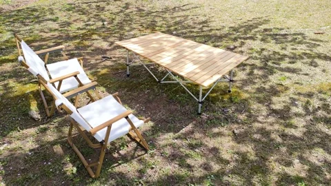 Table and chairs in the shade of a tree Stock Footage 324598954