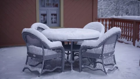 Table and chairs stand outside covered with snow day Vídeos de archivo 240367096