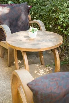 Table and chairs standing in the garden with shadows Stock Photos