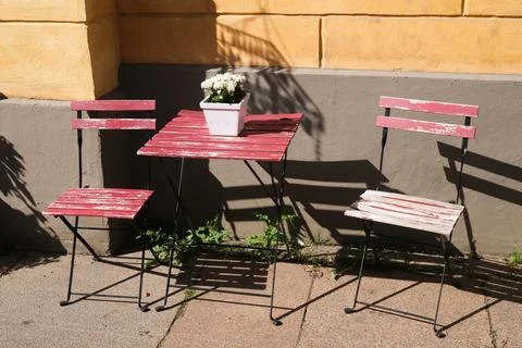 Table and chairs in the sun Stock Photos