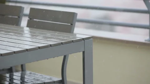 Table and chairs under the rain. Stock Footage 87324062