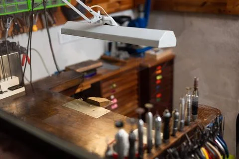 Table and tools of a jewelry workshop, jeweler craftsman. Stock Photos