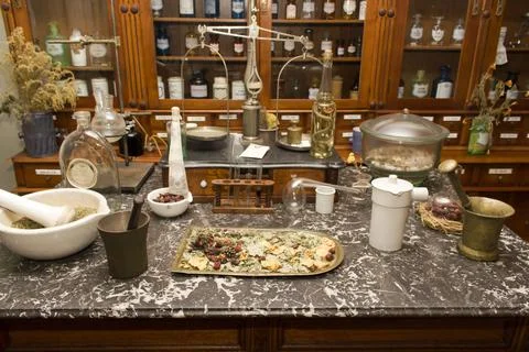 A table with antique instruments for making medicines against the background Stock Photos