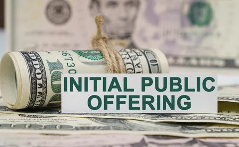 On the table are bills, a bundle of dollars and a sign on which it is written Stock Photos