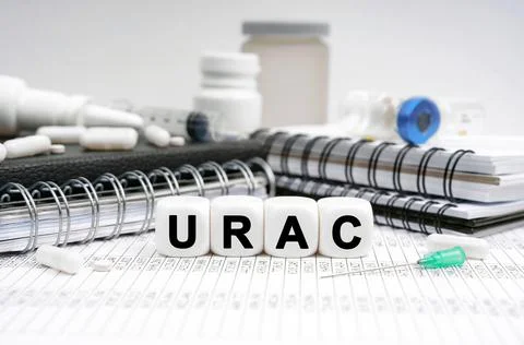 On the table are diaries, medicines and cubes with the inscription - URAC Stock Photos