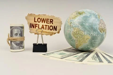 On the table are dollars, a globe and there is a sign with the inscription .. Foto stock